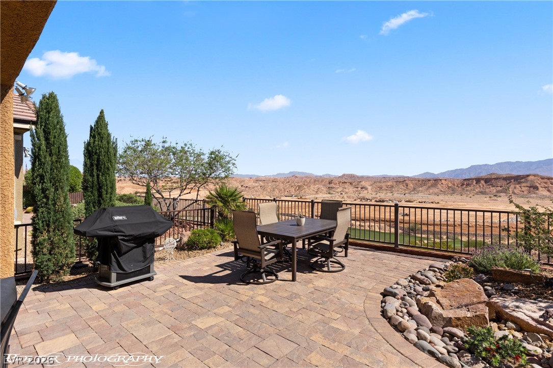 1262 Serenity Ridge Court Mesquite, NV 89034 - Photo 16 of 74 View of patio / terrace featuring outdoor dining space, a grill, and a mountain view