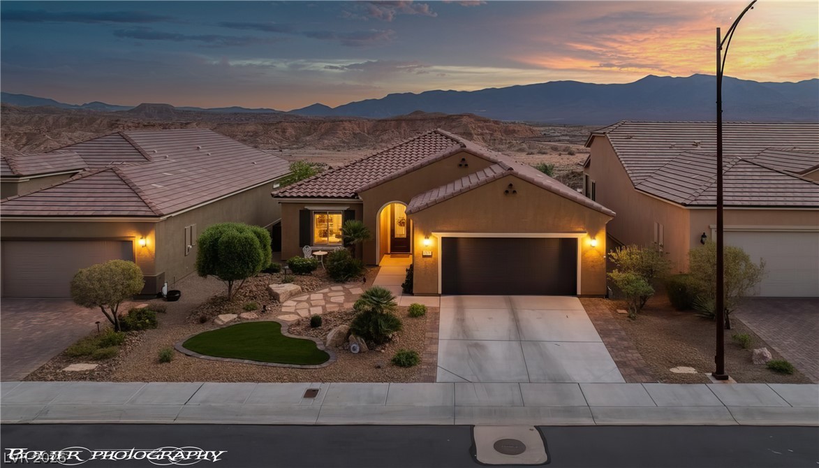1262 Serenity Ridge Court Mesquite, NV 89034 - Photo 2 of 74 View of front of house featuring a garage, stucco siding, and driveway