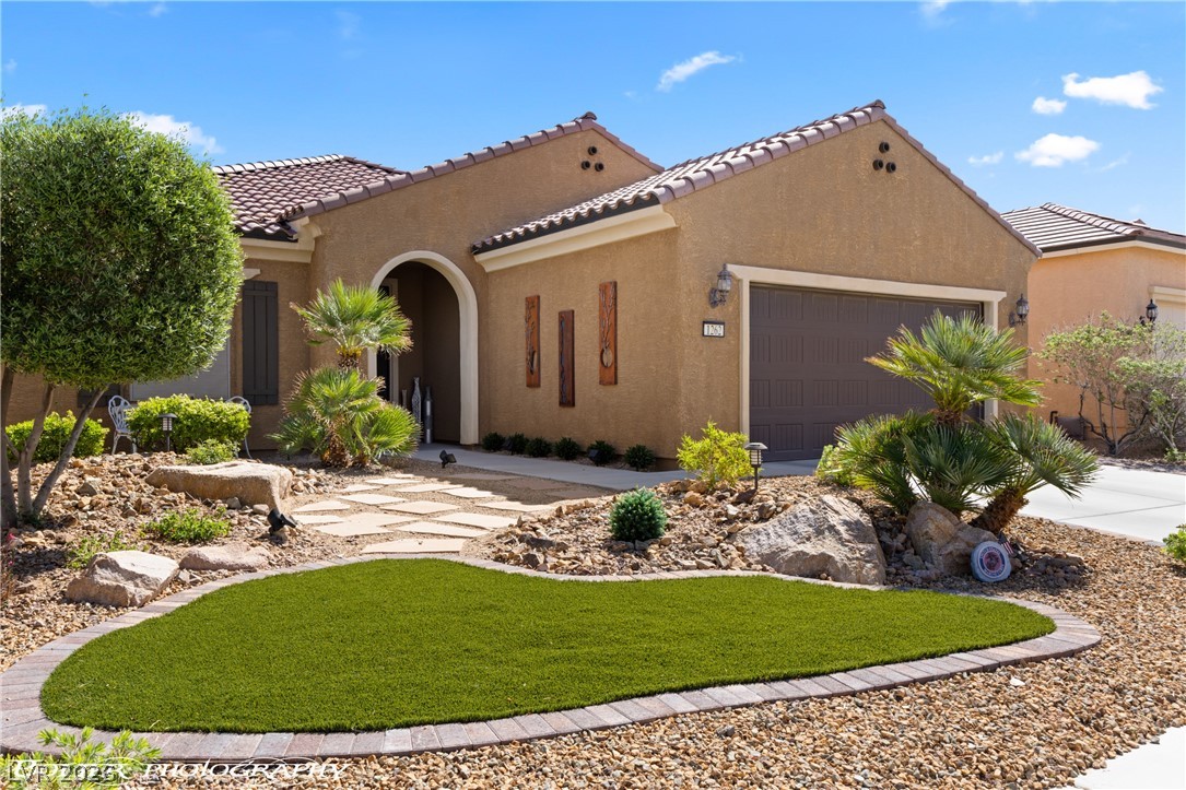 1262 Serenity Ridge Court Mesquite, NV 89034 - Photo 27 of 74 Mediterranean / spanish-style home with stucco siding, a garage, a tile roof, and a front yard