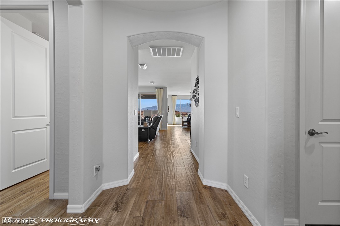 1262 Serenity Ridge Court Mesquite, NV 89034 - Photo 33 of 74 Corridor featuring arched walkways and wood finished floors