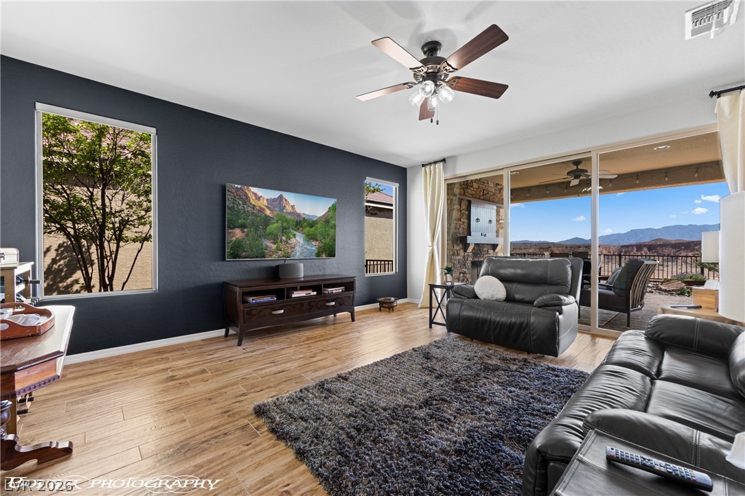 1262 Serenity Ridge Court Mesquite, NV 89034 - Photo 34 of 74 Living room with light wood-style flooring, a ceiling fan, and healthy amount of natural light