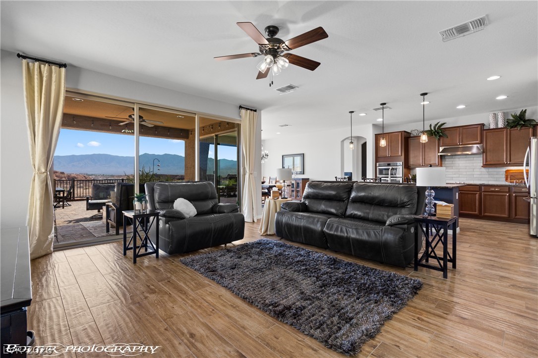1262 Serenity Ridge Court Mesquite, NV 89034 - Photo 35 of 74 Living area featuring a mountain view, ceiling fan, light wood-style flooring, and recessed lighting
