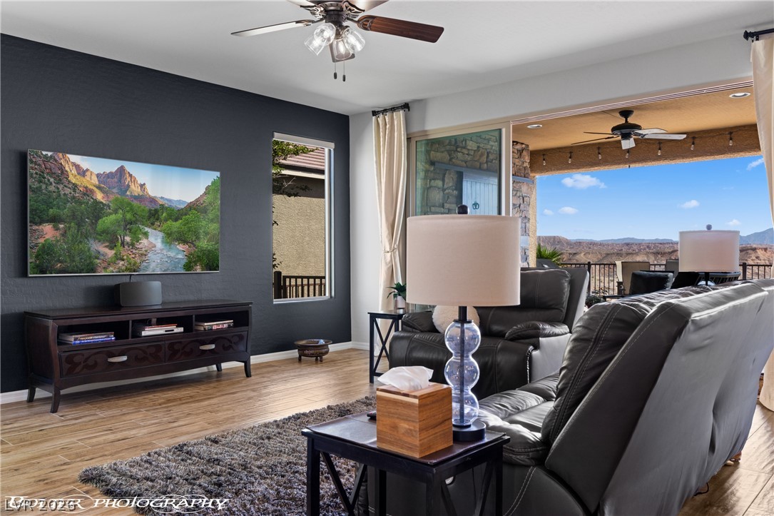 1262 Serenity Ridge Court Mesquite, NV 89034 - Photo 40 of 74 Living room featuring a ceiling fan, light wood-style floors, and a mountain view