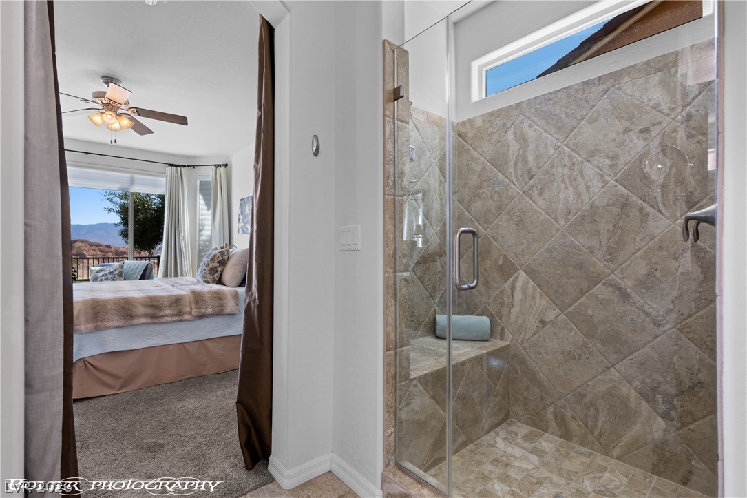 1262 Serenity Ridge Court Mesquite, NV 89034 - Photo 58 of 74 Ensuite bathroom featuring a stall shower, light carpet, and a ceiling fan