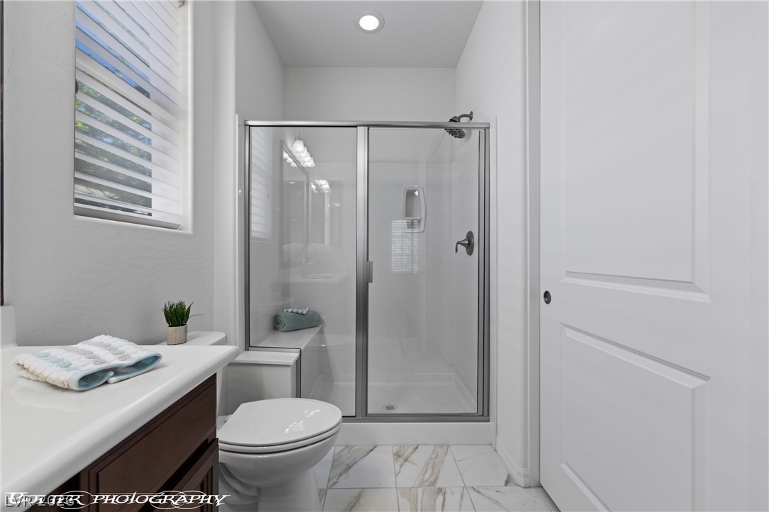1262 Serenity Ridge Court Mesquite, NV 89034 - Photo 64 of 74 Full bath featuring a shower stall, vanity, light marble finish floors, and recessed lighting