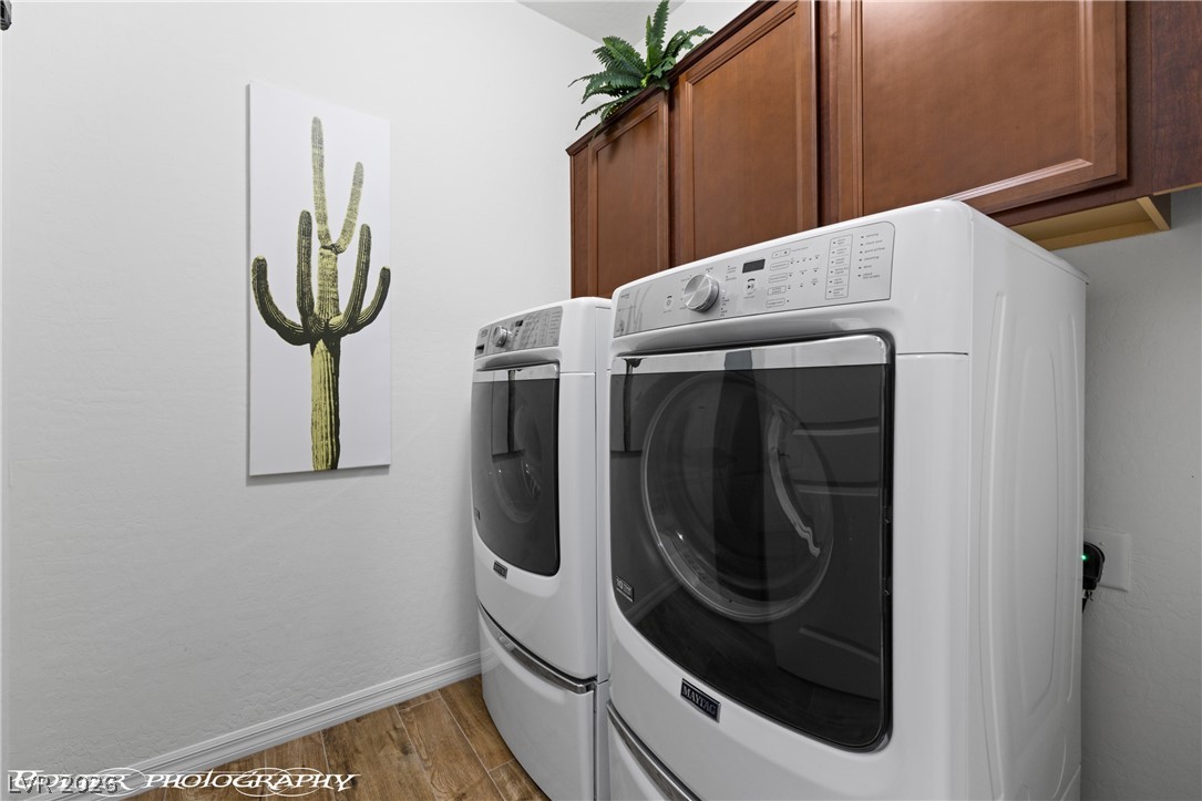 1262 Serenity Ridge Court Mesquite, NV 89034 - Photo 65 of 74 Laundry room featuring separate washer and dryer, light wood-type flooring, and cabinet space