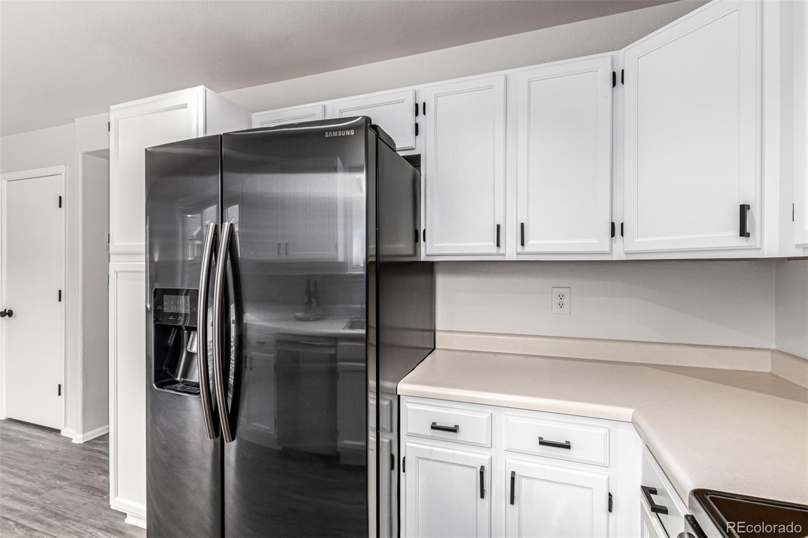 3705 Bucknell Circle Highlands Ranch, CO 80129 - Photo 11 of 42 a close view of a refrigerator in kitchen and white cabinets