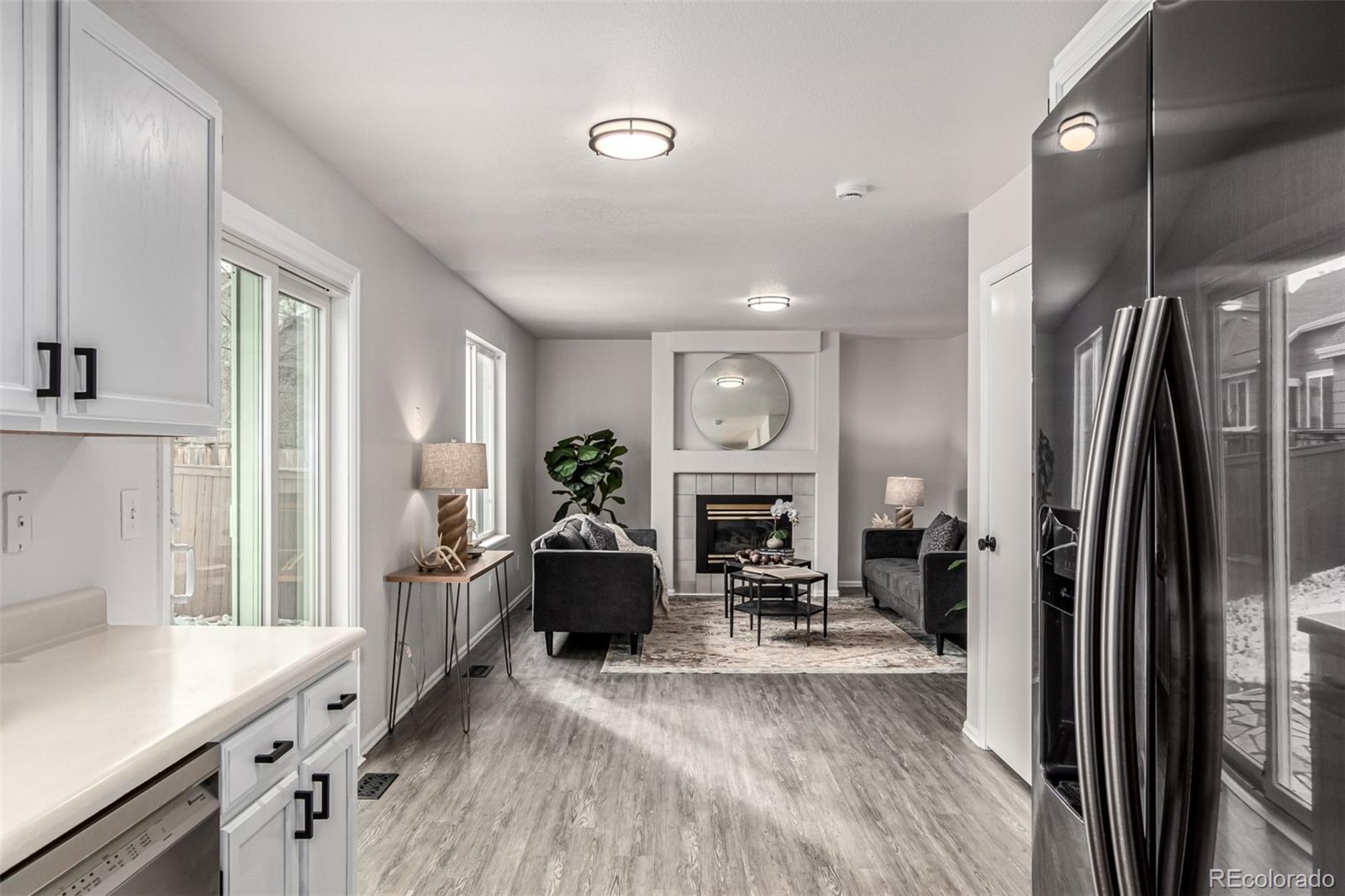 3705 Bucknell Circle Highlands Ranch, CO 80129 - Photo 13 of 42 a living room with furniture and a fireplace