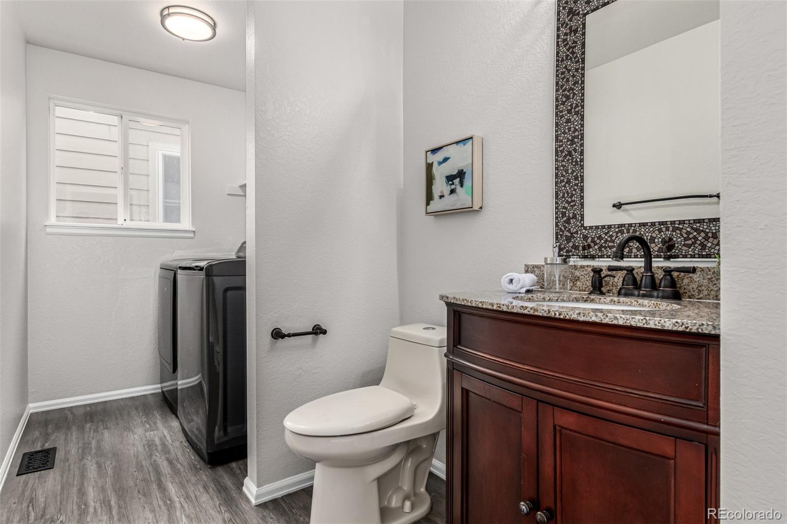 3705 Bucknell Circle Highlands Ranch, CO 80129 - Photo 18 of 42 a bathroom with a granite countertop toilet sink and mirror
