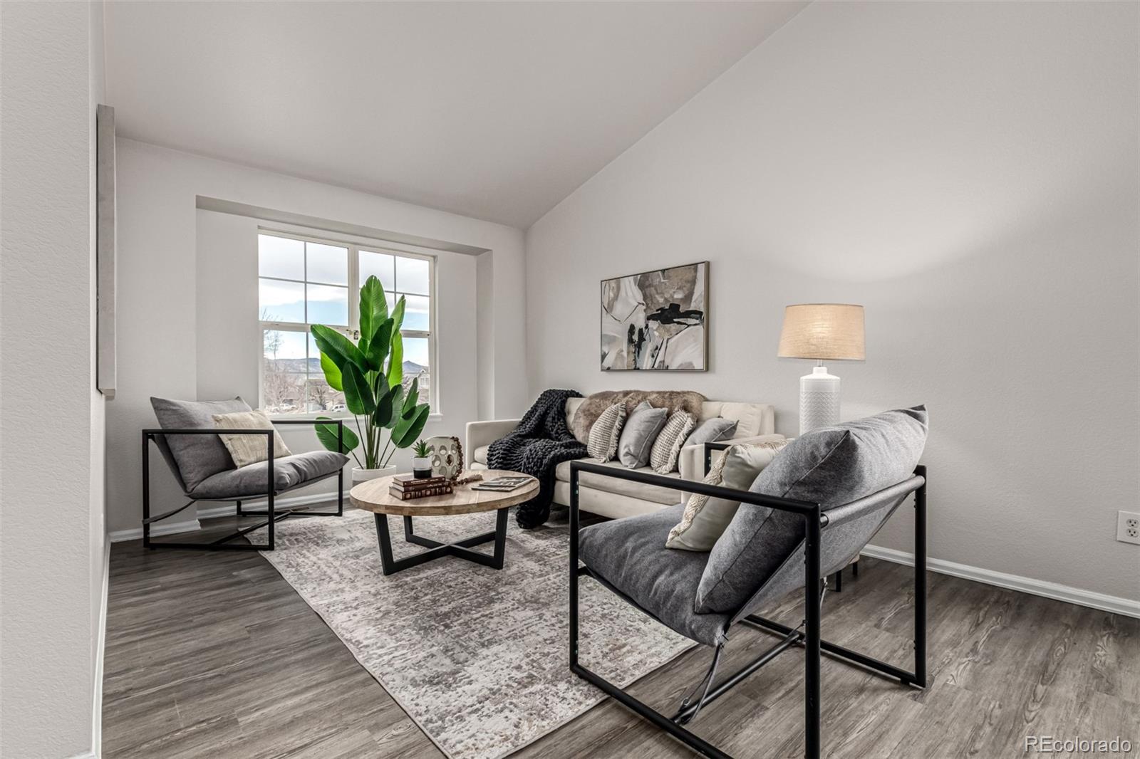 3705 Bucknell Circle Highlands Ranch, CO 80129 - Photo 3 of 42 a living room with furniture and a potted plant on table