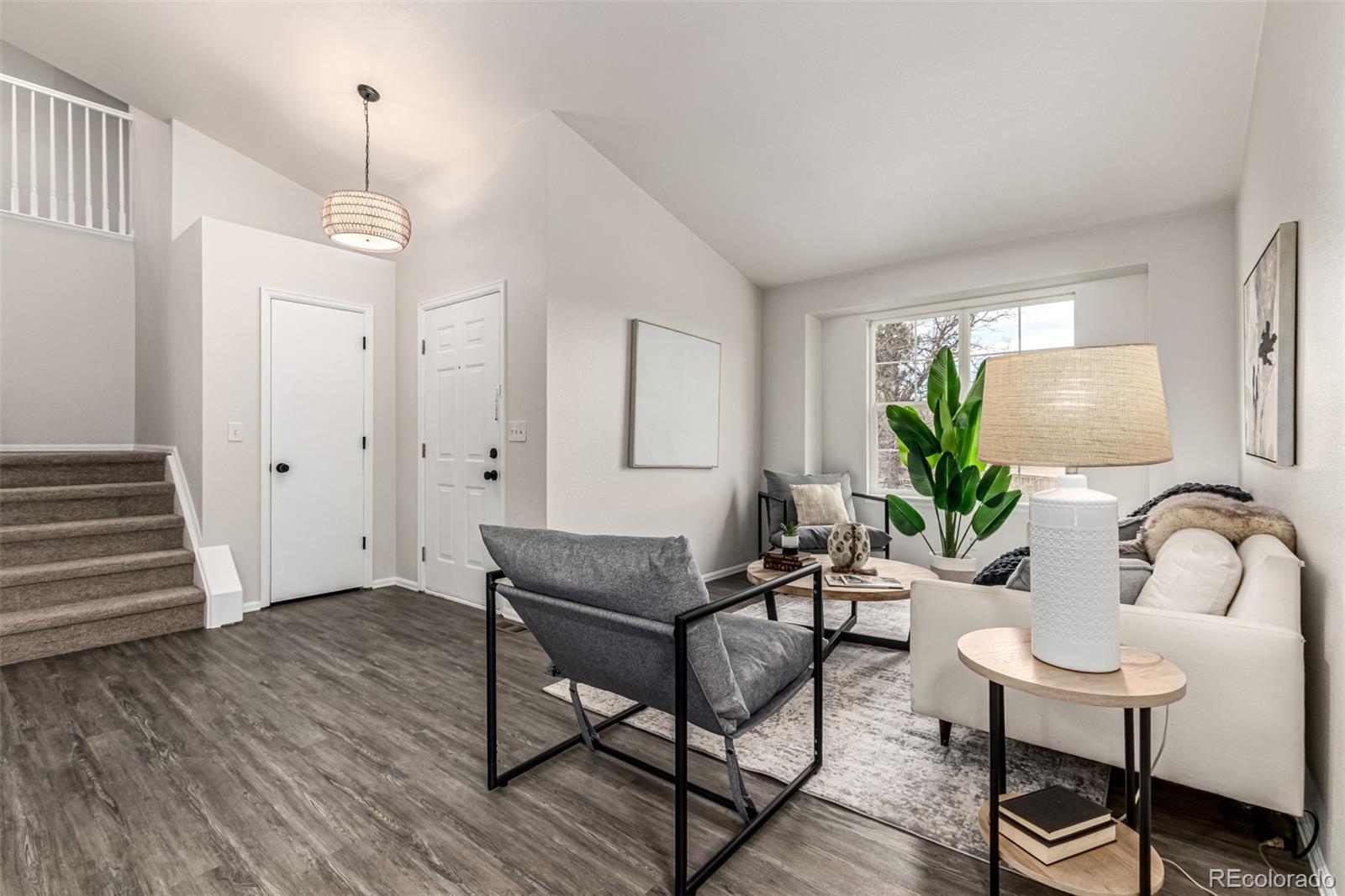 3705 Bucknell Circle Highlands Ranch, CO 80129 - Photo 5 of 42 a dining room with furniture a chandelier and wooden floor