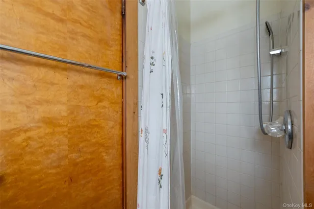 a bathroom with a glass shower door