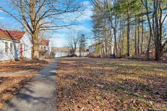 a backyard of a house with large trees