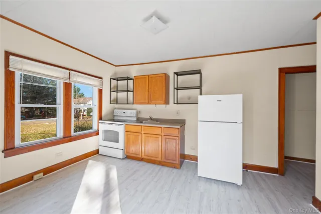 a large white kitchen with window
