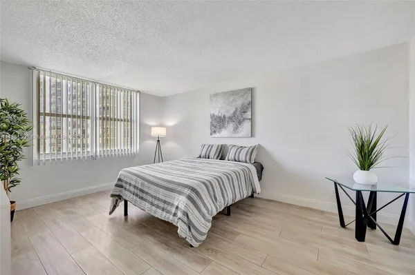 a bedroom with bed and a night stand