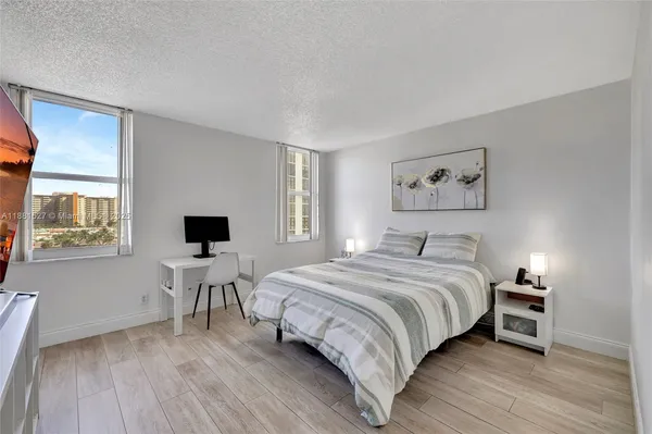 a bedroom with a bed and a painting on the wall