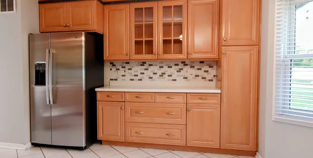 a kitchen with stainless steel appliances granite countertop a refrigerator and a cabinets