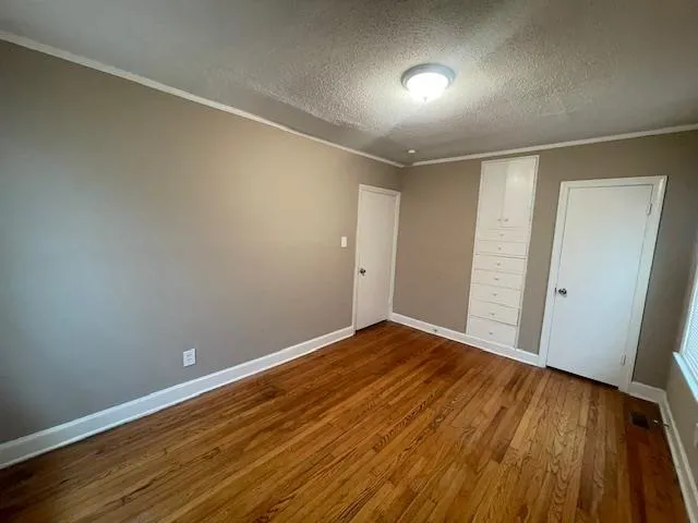 a view of room with wooden floor