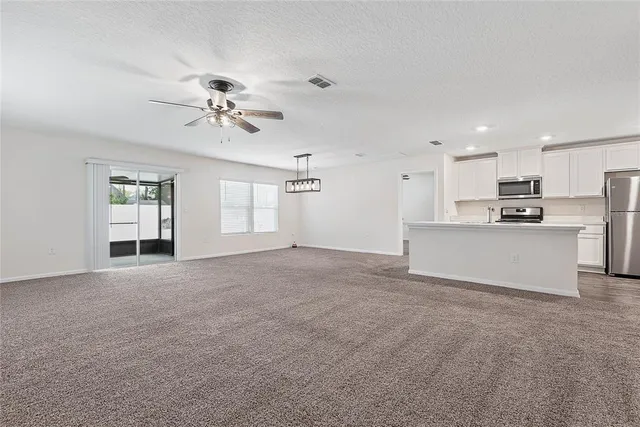 a view of a kitchen with a sink and a refrigerator