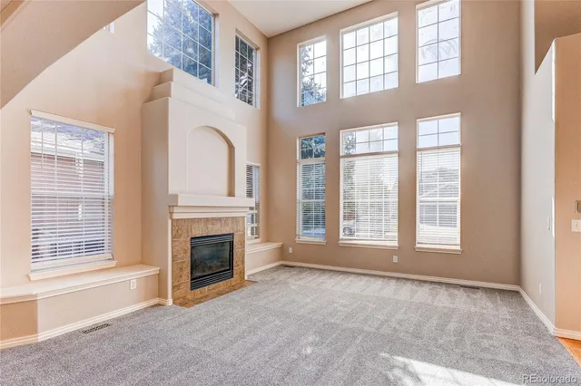 a view of an empty room with a fireplace and a window