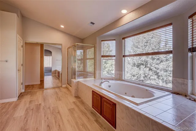 a view of bathroom with bathtub and shower