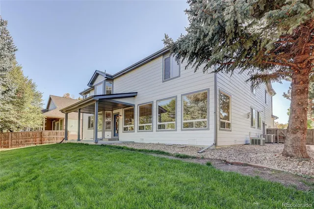 a view of a house with a backyard