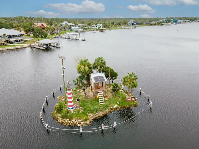 a view of a lake with a table and chairs