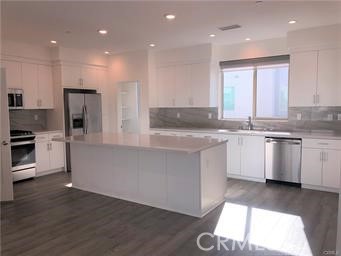 315 Placemark Irvine, CA 92614 - Photo 5 of 23 a kitchen with stainless steel appliances granite countertop a white cabinets and a granite counter tops