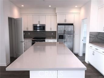 315 Placemark Irvine, CA 92614 - Photo 6 of 23 a large kitchen with stainless steel appliances a refrigerator and a stove top oven