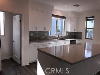 315 Placemark Irvine, CA 92614 - Photo 7 of 23 a kitchen with stainless steel appliances granite countertop a stove a sink and a refrigerator
