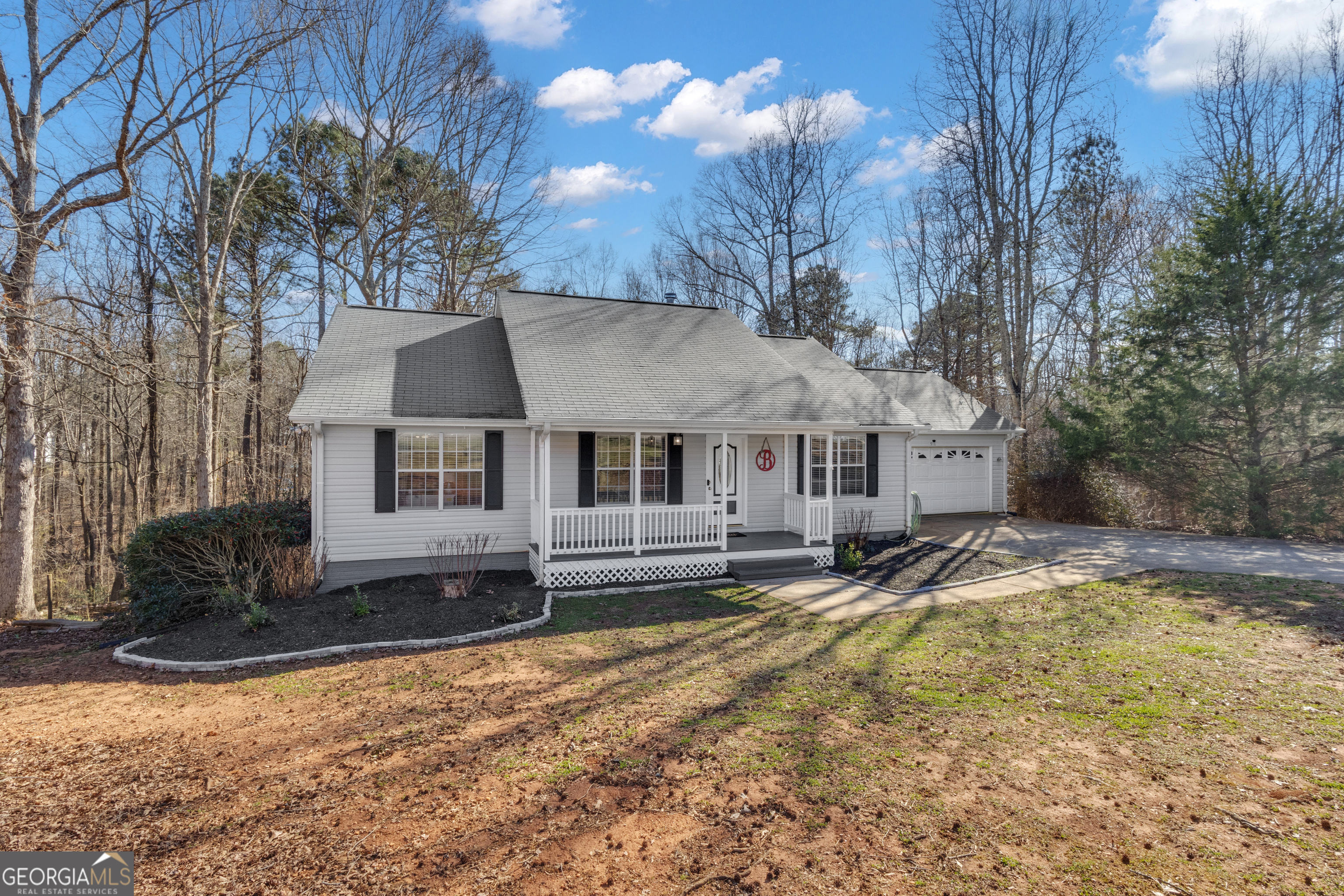 918 Scarletts Walk Locust Grove, GA 30248 - Photo 1 of 1 a view of a house with a yard covered with snow in the background