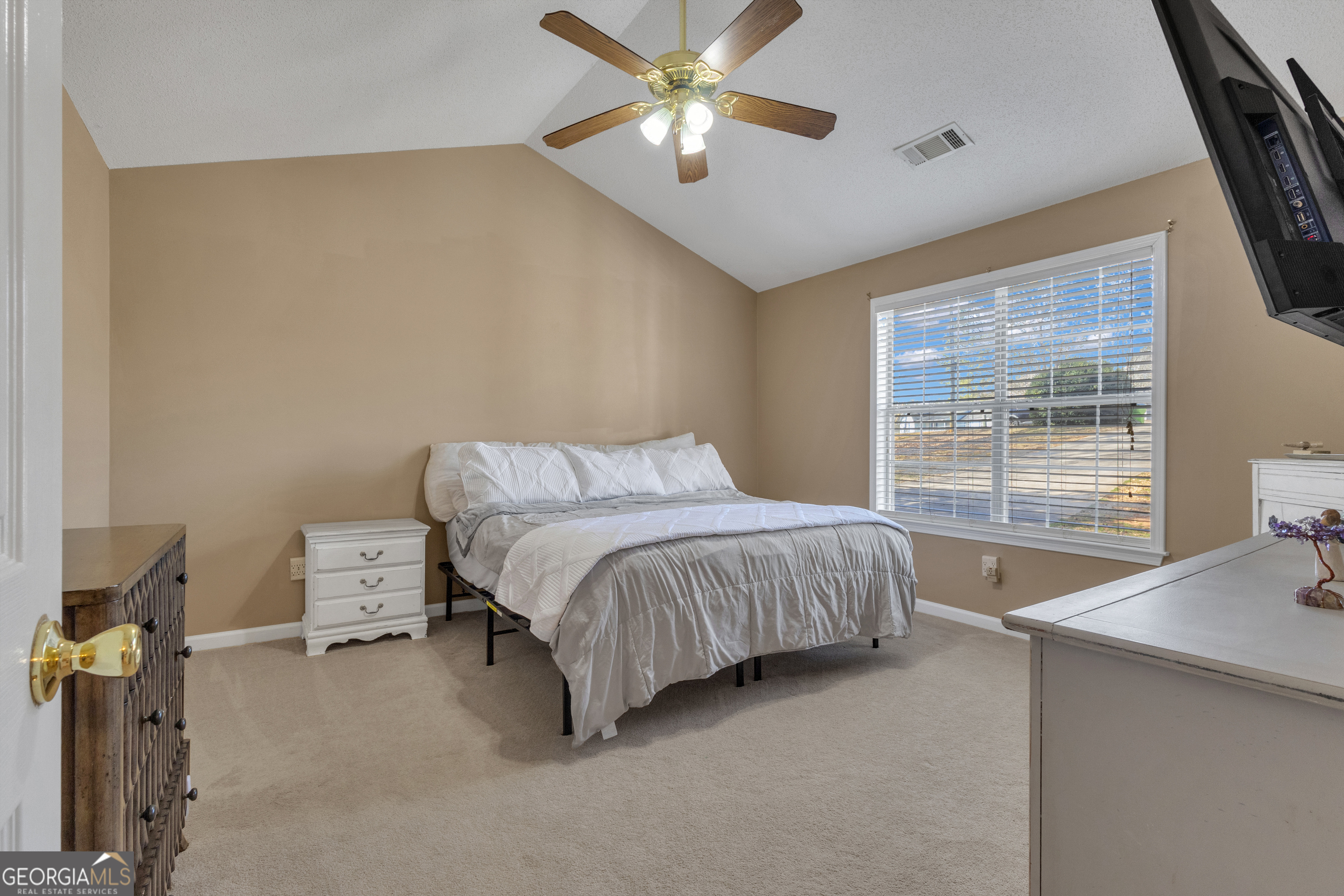 918 Scarletts Walk Locust Grove, GA 30248 - Photo 12 of 46 a bedroom with a bed and a chandelier