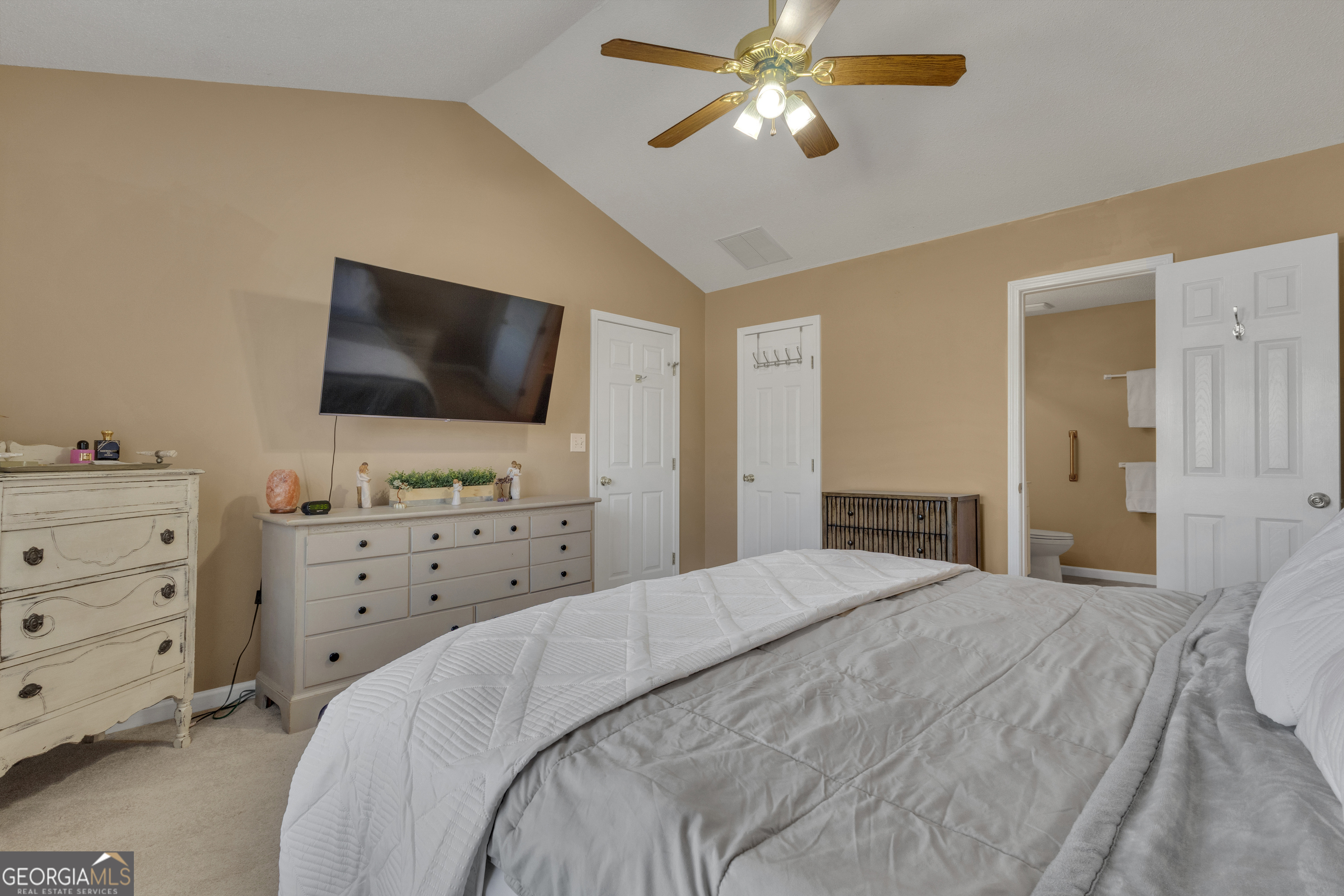 918 Scarletts Walk Locust Grove, GA 30248 - Photo 13 of 46 a bedroom with a bed and a flat screen tv