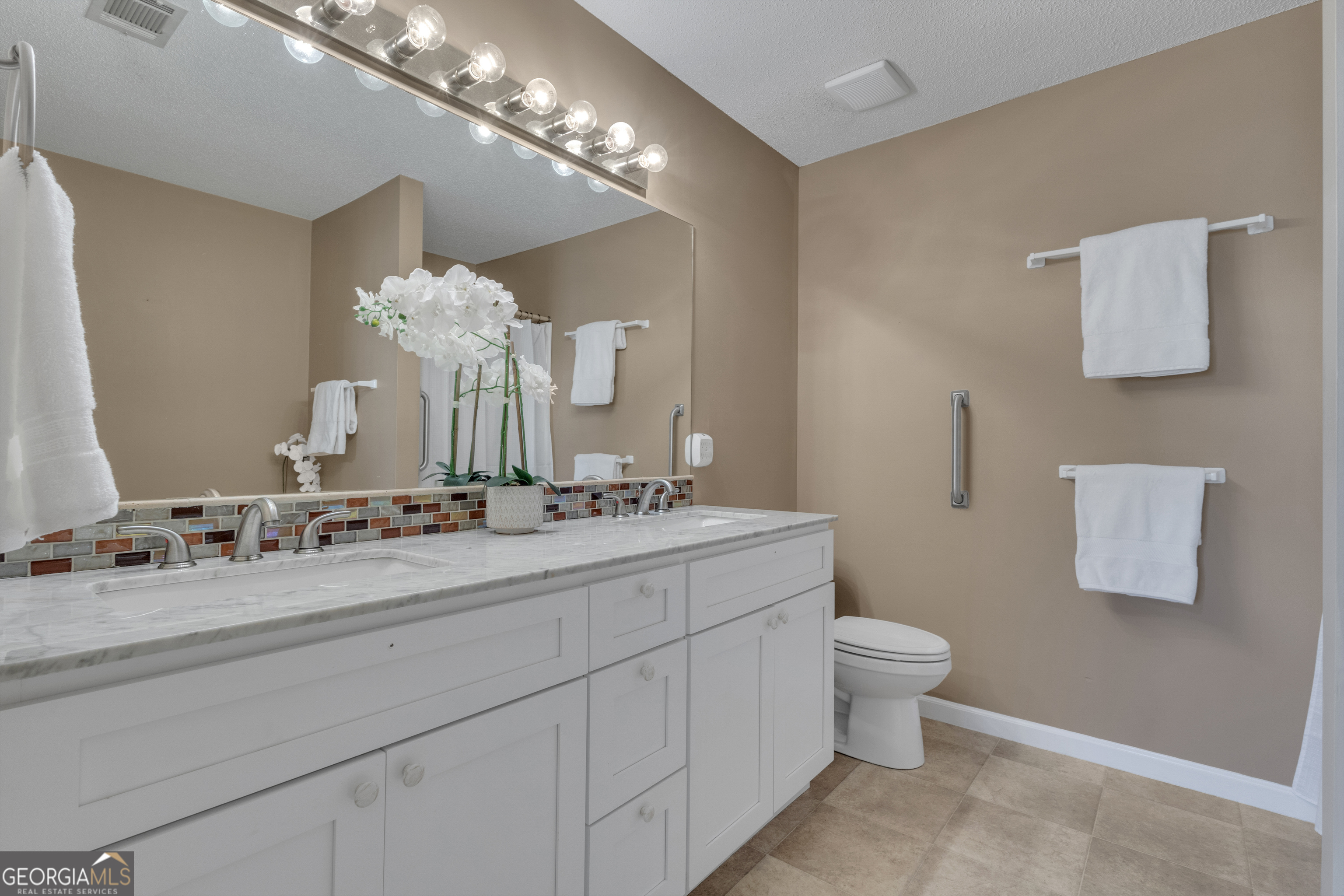 918 Scarletts Walk Locust Grove, GA 30248 - Photo 14 of 46 a bathroom with a double vanity sink and a mirror