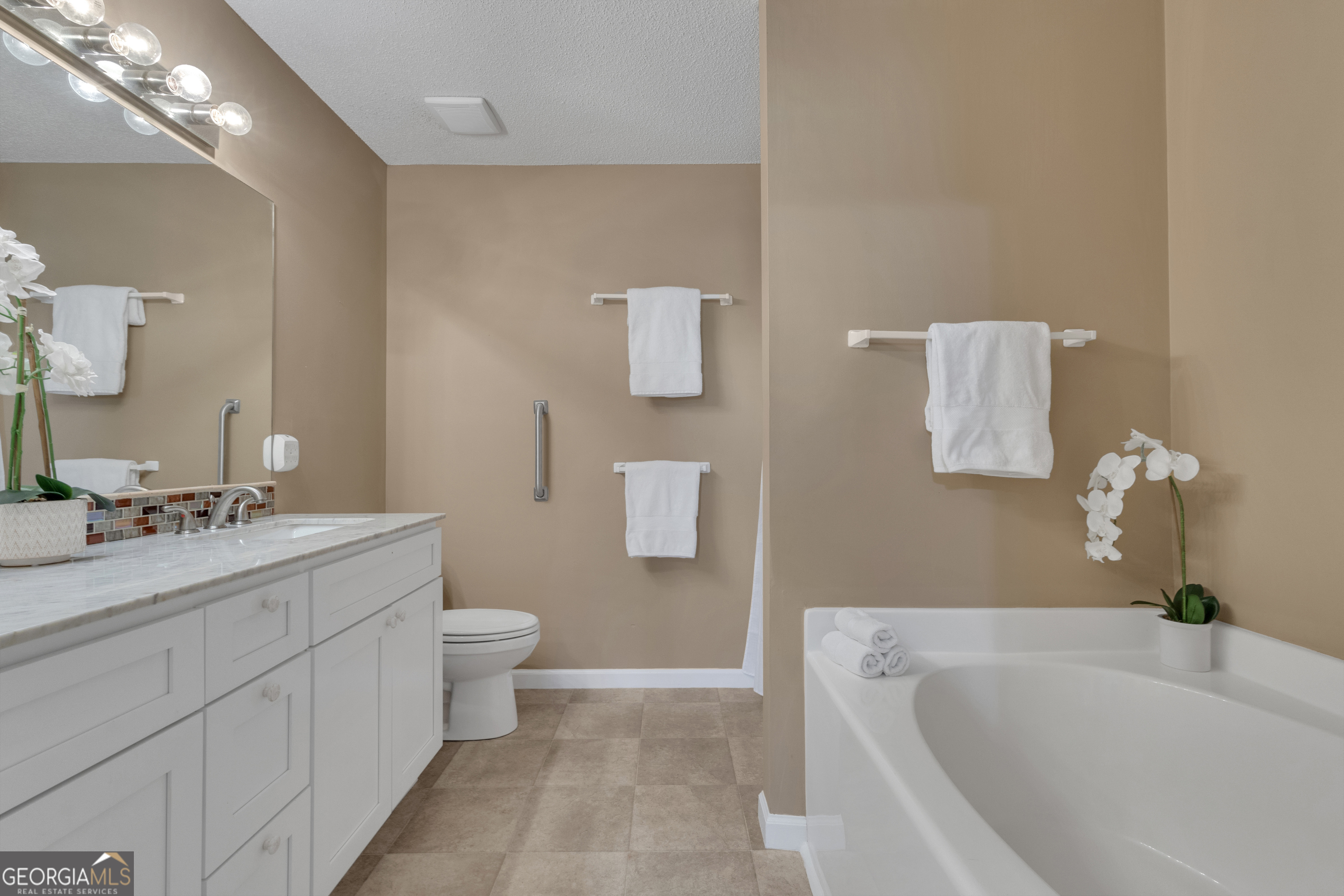 918 Scarletts Walk Locust Grove, GA 30248 - Photo 15 of 46 a bathroom with a sink a toilet and mirror
