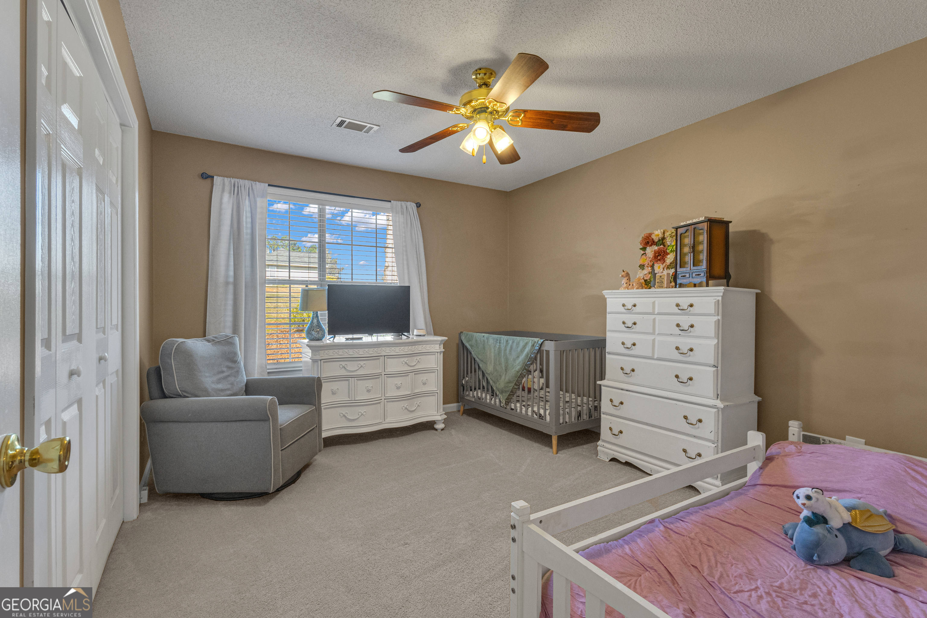 918 Scarletts Walk Locust Grove, GA 30248 - Photo 17 of 46 a bedroom with a bed and a couch