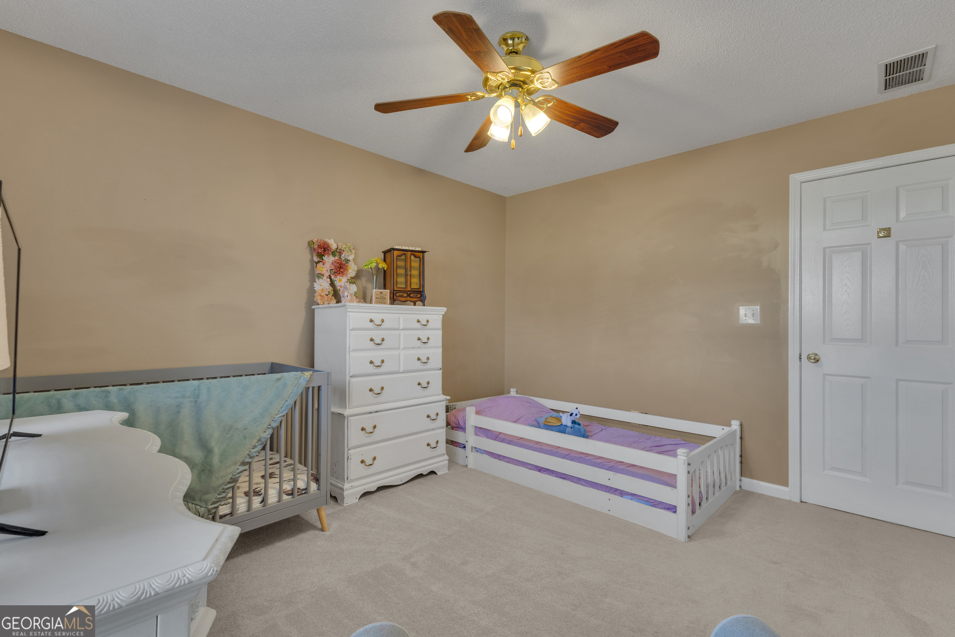 918 Scarletts Walk Locust Grove, GA 30248 - Photo 18 of 46 a bedroom with a bed and a chandelier