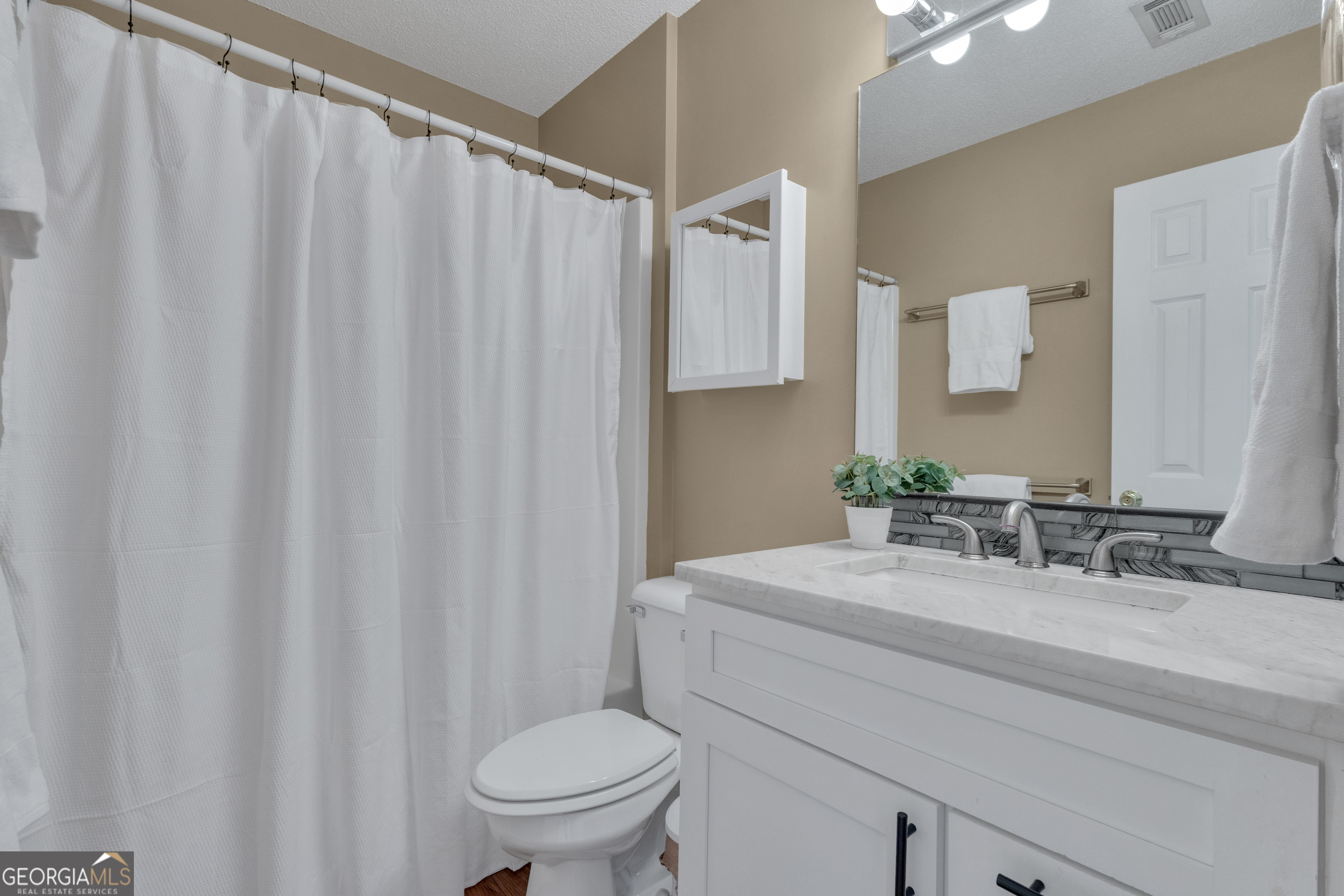 918 Scarletts Walk Locust Grove, GA 30248 - Photo 19 of 46 a bathroom with a sink mirror and toilet