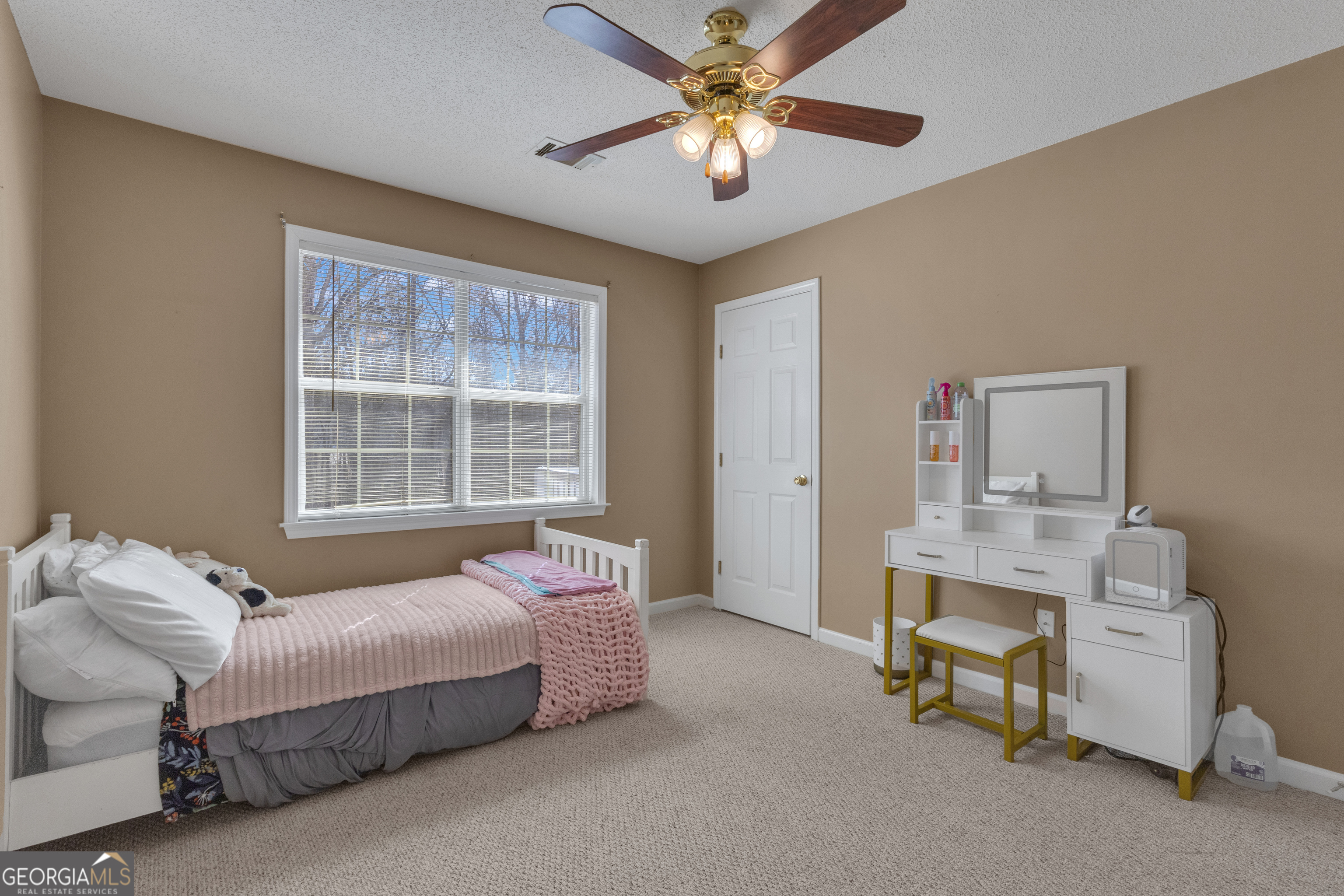 918 Scarletts Walk Locust Grove, GA 30248 - Photo 21 of 46 a bedroom with a bed and a chandelier