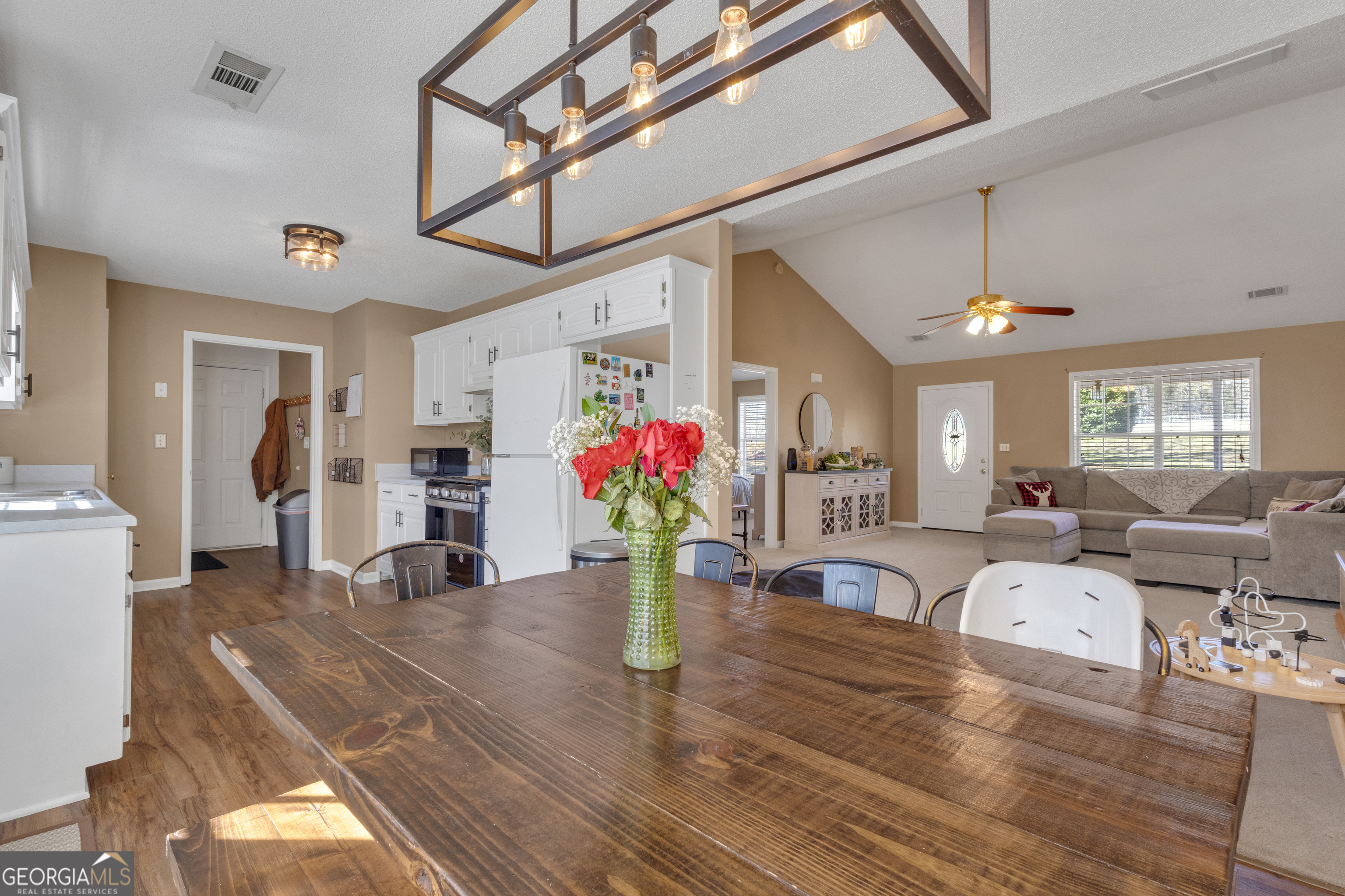 918 Scarletts Walk Locust Grove, GA 30248 - Photo 23 of 46 a living room with furniture potted plant and kitchen view