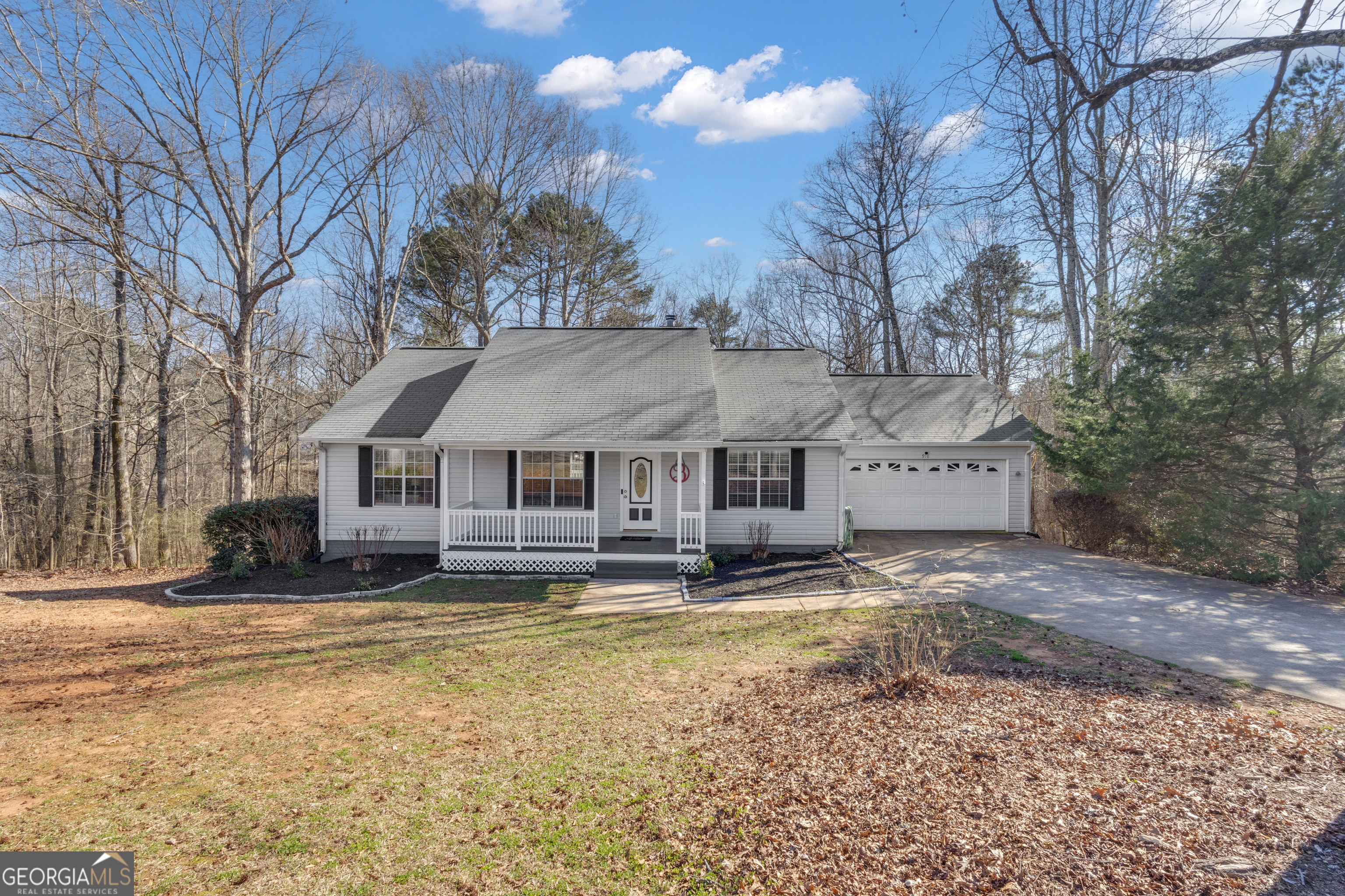 918 Scarletts Walk Locust Grove, GA 30248 - Photo 3 of 46 a house that has a large tree in front of it