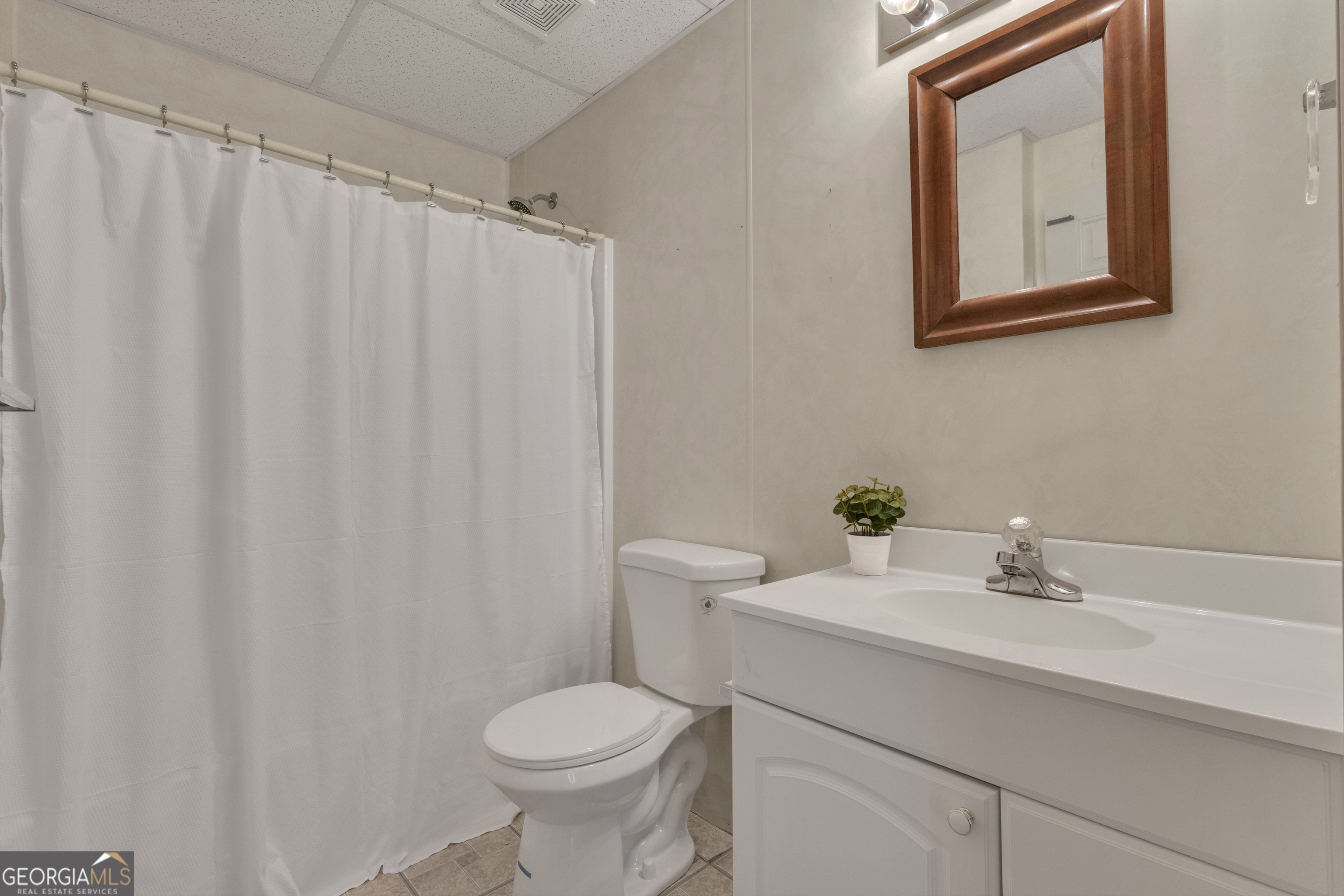 918 Scarletts Walk Locust Grove, GA 30248 - Photo 32 of 46 a bathroom with a sink a toilet and a mirror