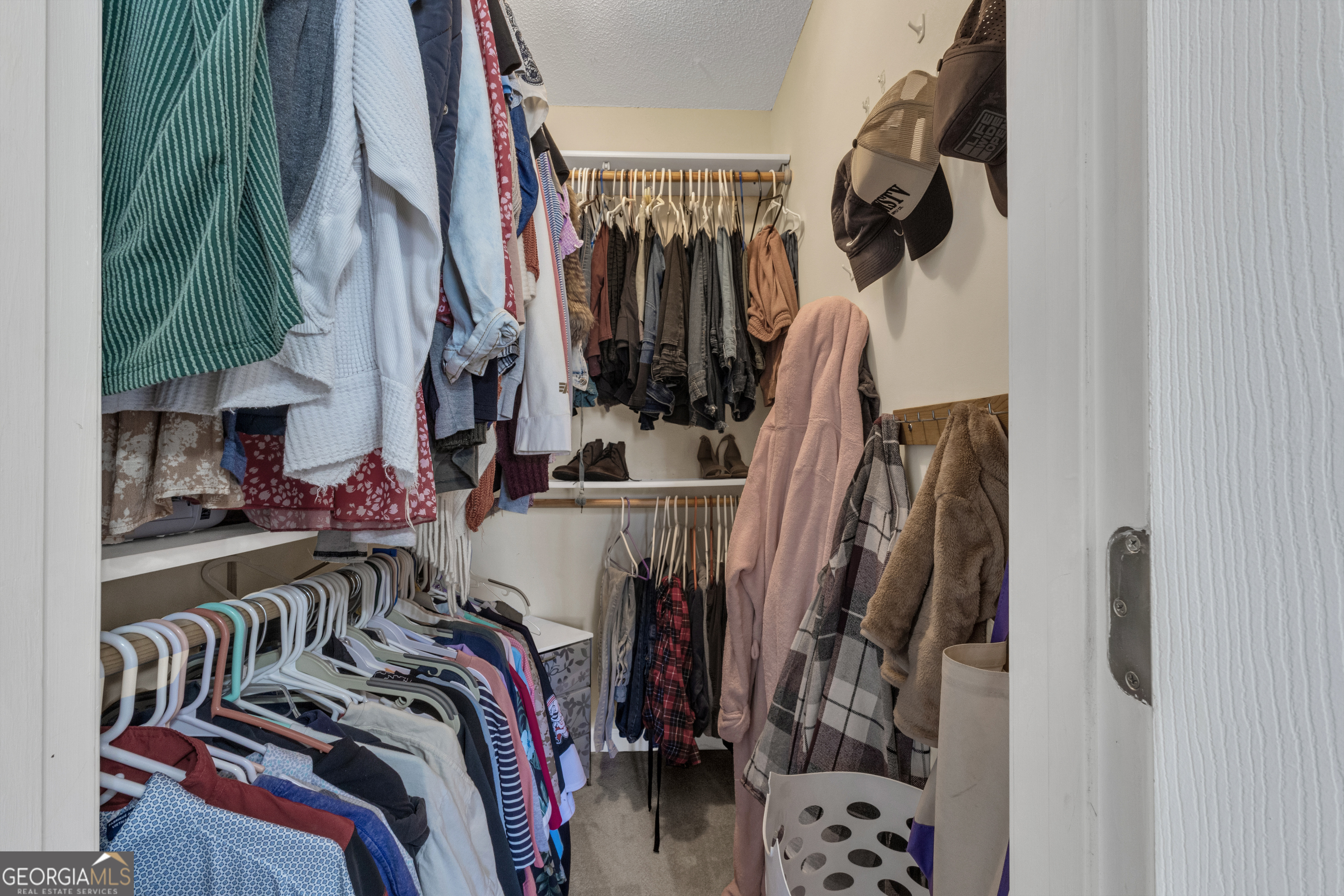 918 Scarletts Walk Locust Grove, GA 30248 - Photo 44 of 46 a view of walk in closet with clothes and shoes