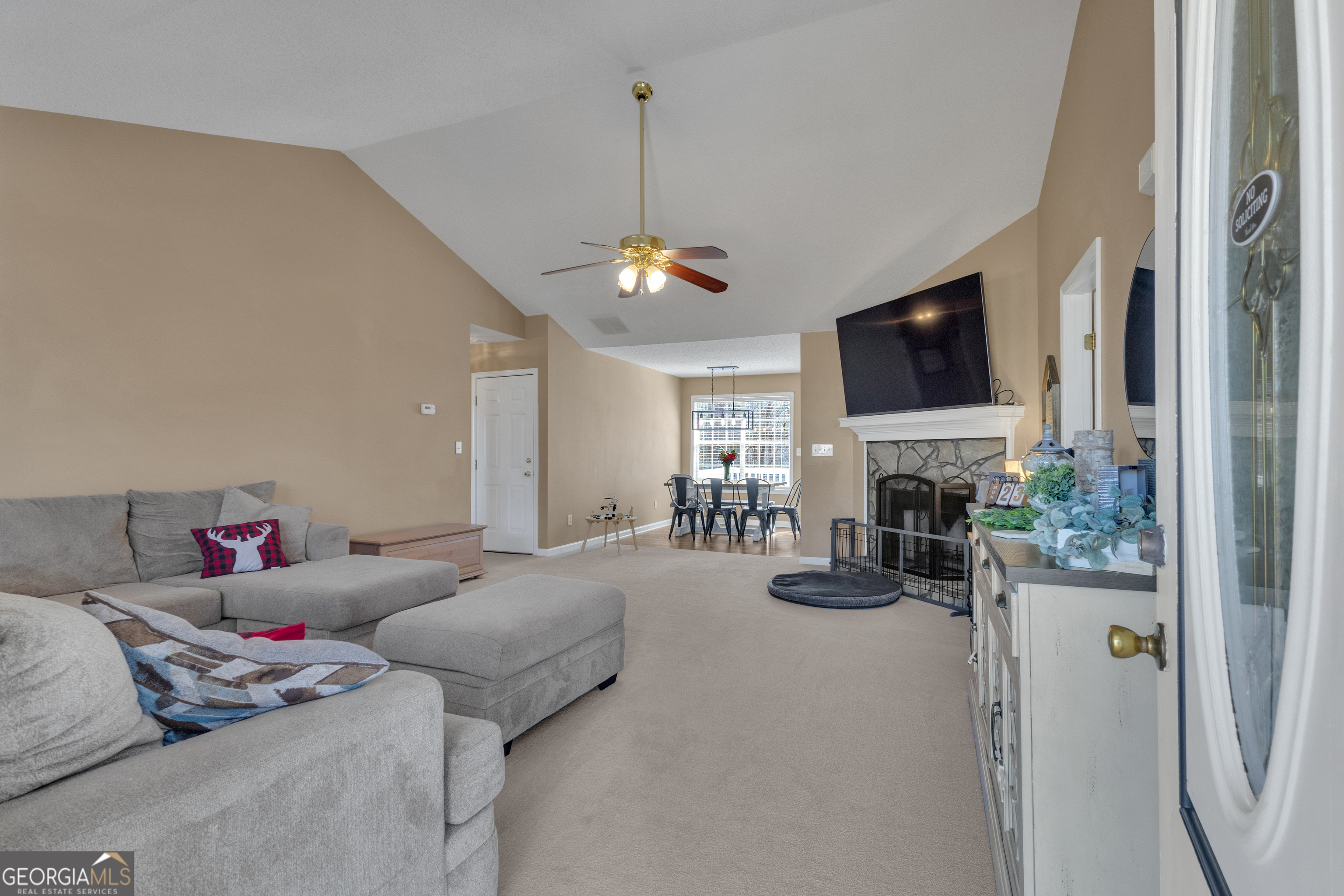 918 Scarletts Walk Locust Grove, GA 30248 - Photo 6 of 46 a living room with furniture a flat screen tv and a fireplace