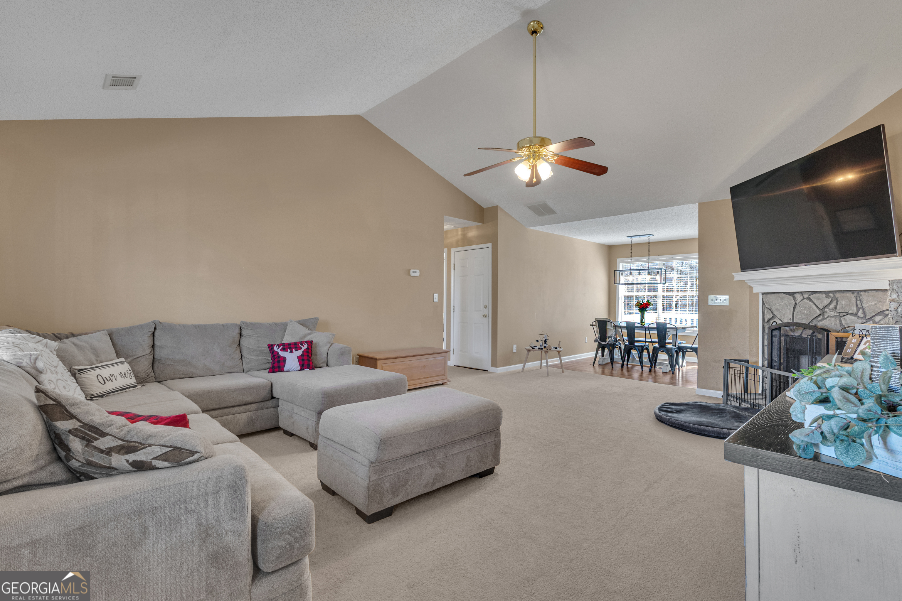 918 Scarletts Walk Locust Grove, GA 30248 - Photo 7 of 46 a living room with furniture a fireplace and a flat screen tv