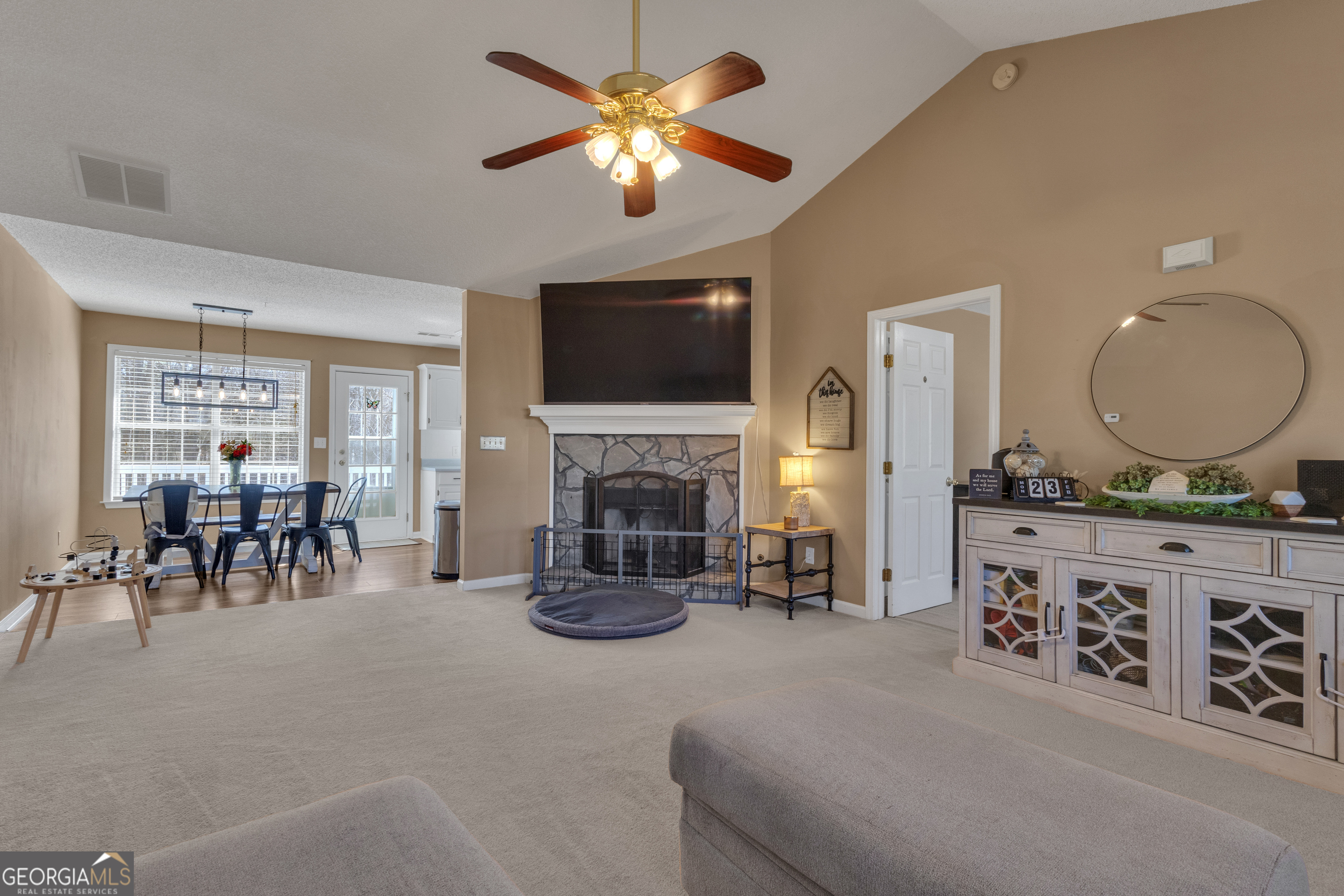 918 Scarletts Walk Locust Grove, GA 30248 - Photo 8 of 46 a living room with furniture a fireplace and a flat screen tv
