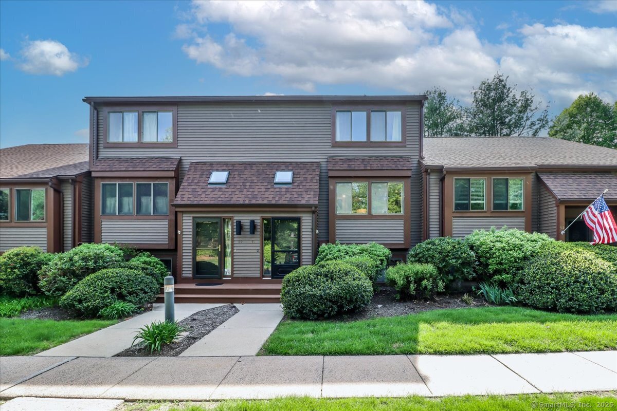a front view of a house with garden