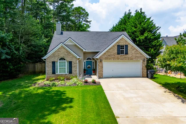 a front view of house with yard and green space