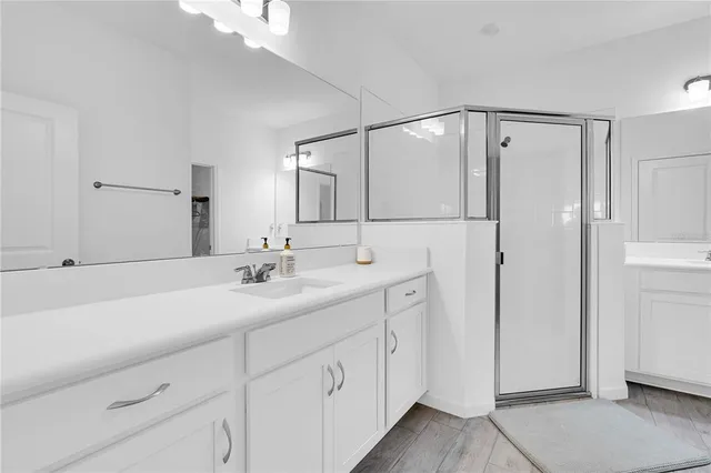 a bathroom with a double vanity sink and mirror