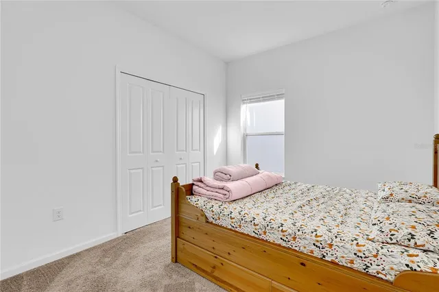 a bedroom with a bed and window